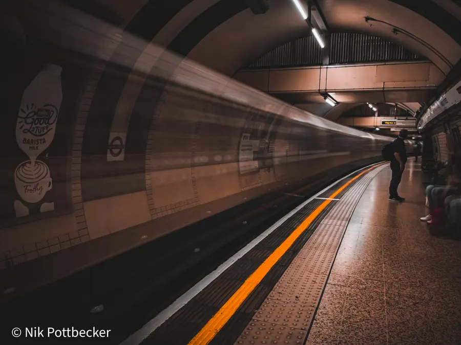 London Underground platform with motion blur of a passing train