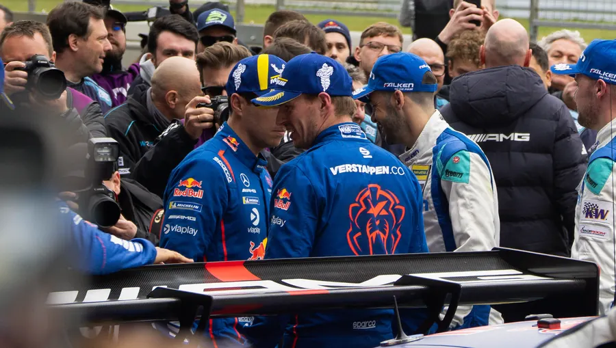 Verstappen.com Racing team members talking in the pit lane at the NLS