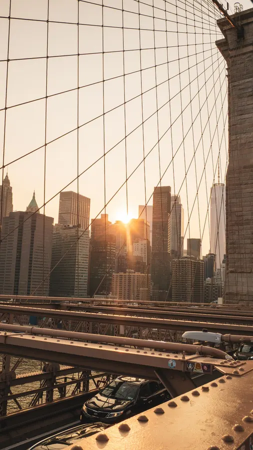 Sunset over Manhattan through the cables of the Brooklyn Bridge